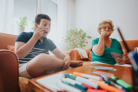 Grandmother and grandson enjoying a fun card game at home