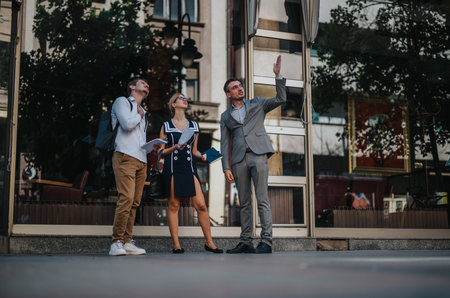 Businesspeople meeting outdoors discussing new strategies in urban setting, analyzing reports for potential growth and successの写真素材