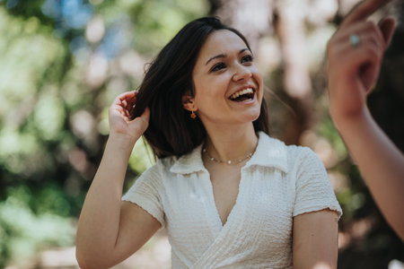 Smiling woman enjoying a sunny day in a lush green parkの写真素材