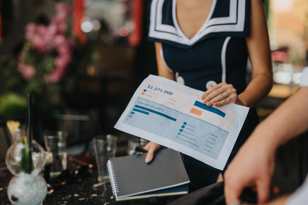 Businesswoman presenting financial report during a meeting at a cafeの写真素材
