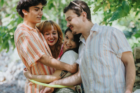 Group of friends embracing outdoors in a joyful momentの写真素材