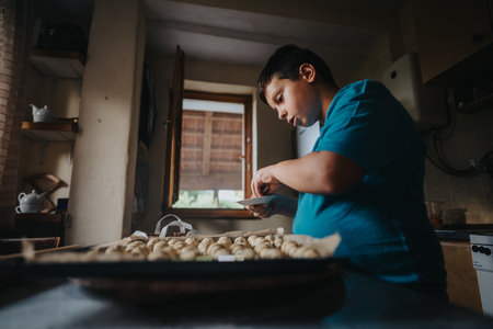 Young boy focused on preparing homemade cookies in the kitchen