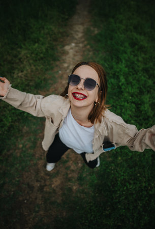 Happy young woman with sunglasses enjoying outdoor freedom and natureの写真素材