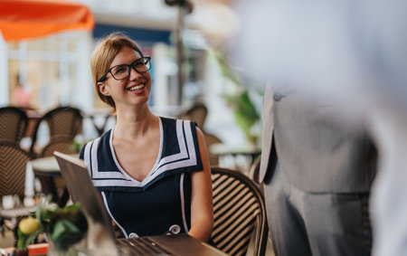 Business professionals having a meeting outdoors discussing sales and marketing strategies with a focus on growth and collaborationの写真素材