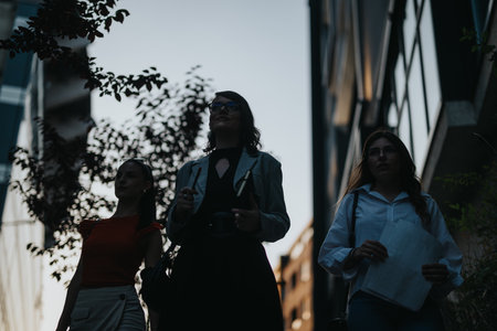 Businesswomen walking through city street in evening lighting