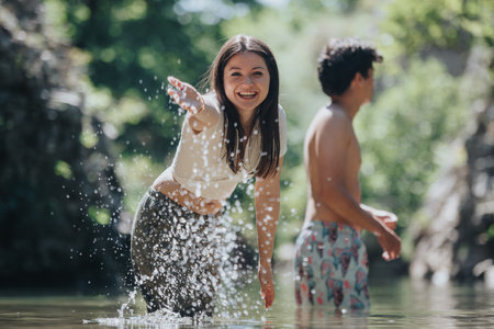 Young friends enjoying a refreshing day at the riverの写真素材