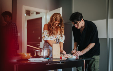 Young couple preparing a meal in a modern kitchenの写真素材