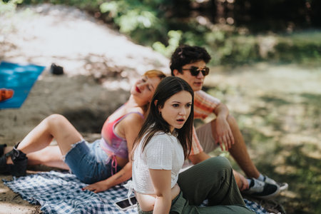 Group of friends enjoying a relaxed picnic in nature setting