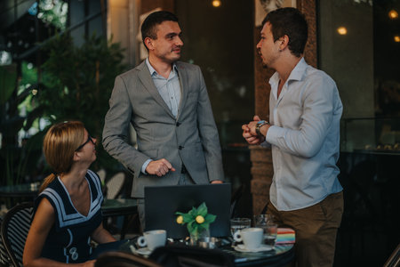 Businesspeople engaging in a lively discussion at an outdoor cafe, fostering teamwork and...