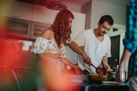 Couple cooking together in a modern kitchen settingの写真素材