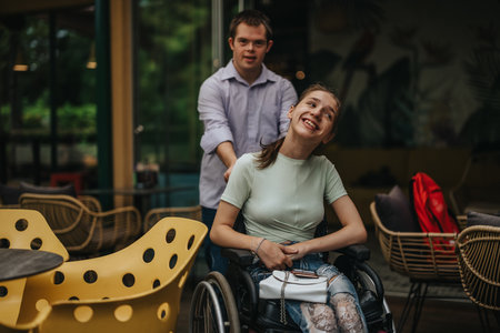 Boy joyfully pushing girl in wheelchair