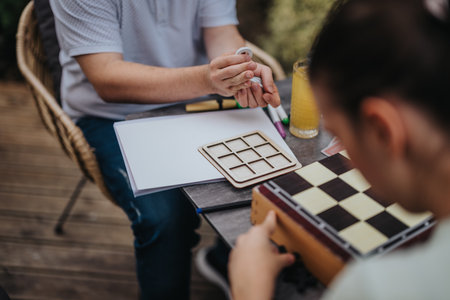 People engaged in a strategic game session outdoorsの写真素材