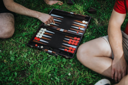 Outdoor backgammon game on grass with friends in the park