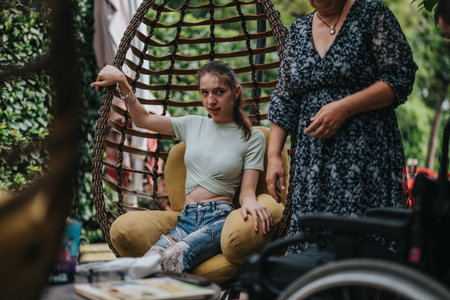 Disabled girl in an outdoor setting with a companionの写真素材