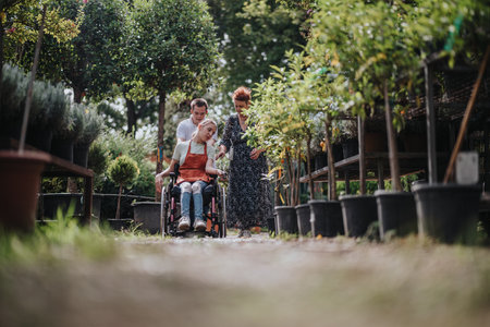 Male with Down syndrome and woman in wheelchair exploring gardenの写真素材
