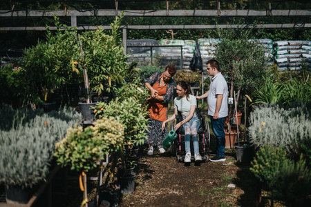 Inclusive gardening group exploring greenery in a nursery settingの写真素材