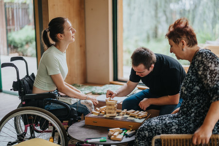 Inter generational group playing building blocks game togetherの写真素材