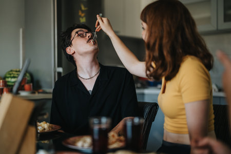 Young couple sharing a meal at a casual dining tableの写真素材