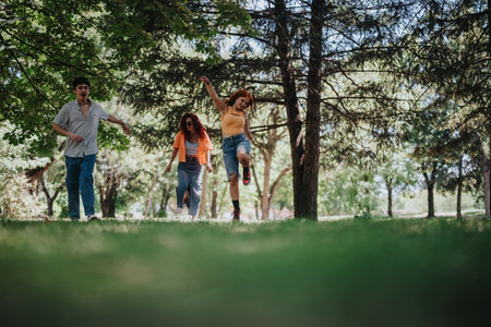 Young teenagers having fun in the park showcasing friendship, joy and moments of laughter and happinessの写真素材
