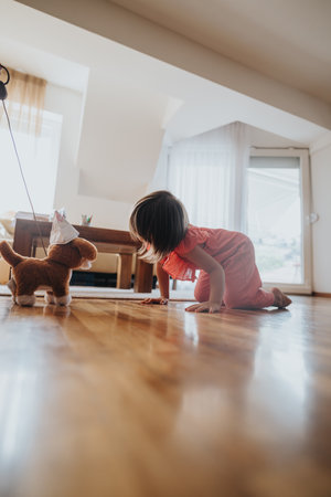 Child playing on floor with toy dog in cozy living roomの写真素材
