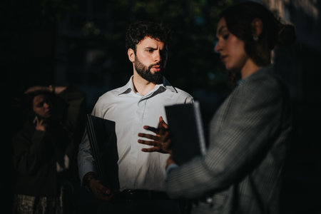 Young business associates discussing project ideas and strategies in an urban city areaの写真素材
