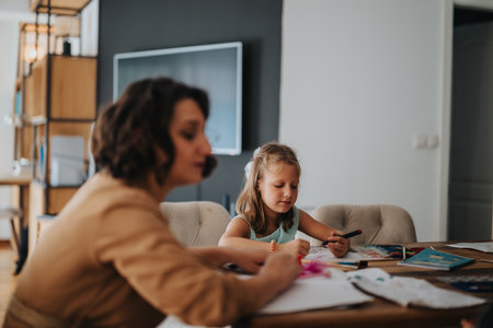 Mother and daughter enjoying quality time with creative drawingの写真素材
