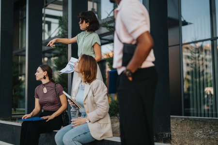 Team members discussing project plans outside modern office