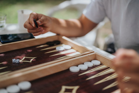 Close-up of people playing backgammon outdoors on a sunny day