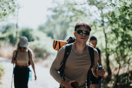 Group of friends hiking in the forest with gear and enjoying outdoor adventure