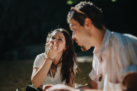 Young couple enjoying a relaxing outdoor picnic by the river