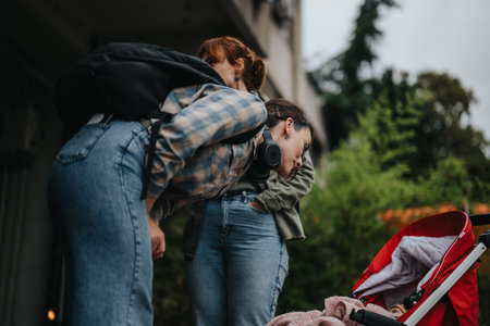 Women exploring the city with a baby in stroller outdoorsの写真素材
