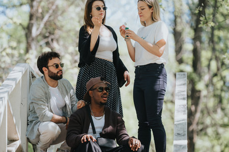 Carefree friends enjoying a sunny day in the urban park, casual lifestyle and relaxationの写真素材