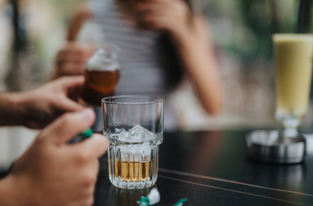 Refreshing drink with ice cubes on a cafe table settingの写真素材