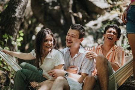 Group of friends enjoying outdoors in the sun on hammockの写真素材