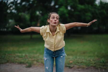 Girl having fun alone in the park, making playful expressions and enjoying the outdoors