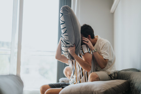 Friends having fun with a pillow fight at home