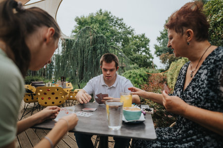 Family enjoying a card game together in outdoor settingの写真素材