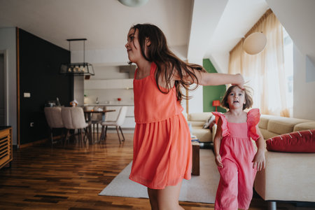 Two young girls playing joyfully in a bright modern living room