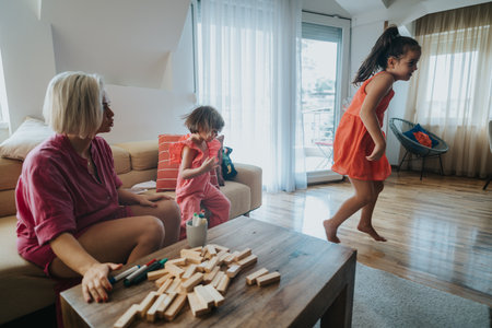 Family enjoying playful moments indoors with happy childrenの写真素材