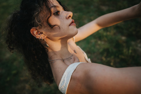 Joyful young girl dancing outdoors in a sunny park setting