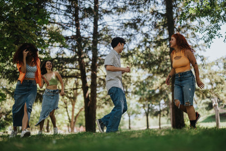 Group of young friends having fun and creating memories in a parkの写真素材