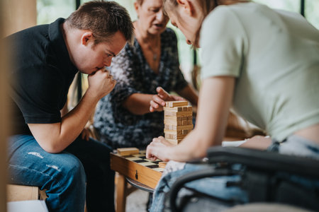 Boy with Down syndrome and friends playing blocks togetherの写真素材