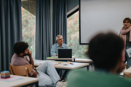 Elderly professor engaging with students in a classroom settingの写真素材