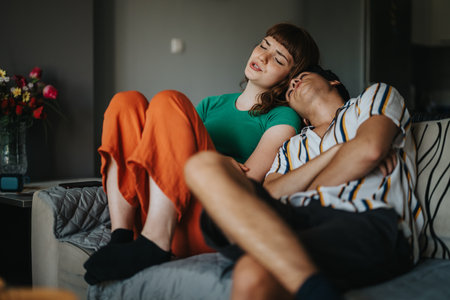 Couple relaxing at home on a cozy sofa during the dayの写真素材