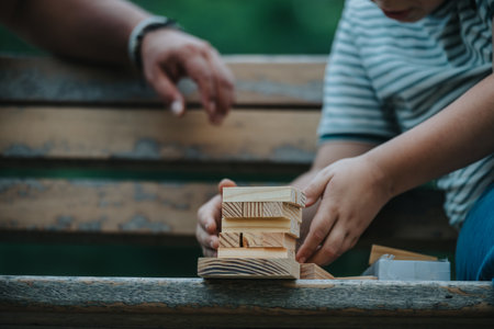 Father and son bonding over building blocks in parkの写真素材