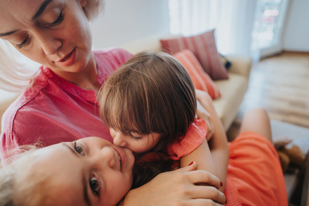Mother embraces children in a warm and loving family momentの写真素材