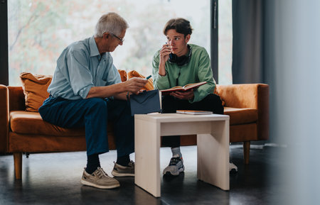 Elderly man and young adult engaged in thoughtful discussion