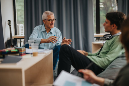 Professor discussing with students in a relaxed settingの写真素材