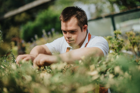 Young gardener with Down syndrome tending to plants outdoors