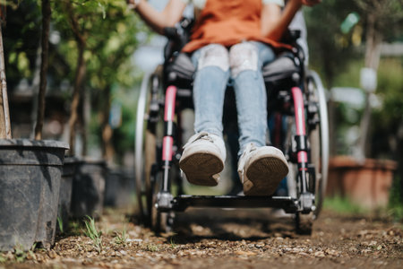 Woman in wheelchair enjoying a peaceful day in the gardenの写真素材
